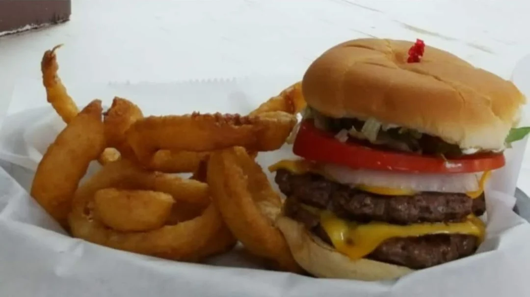 Two-patty cheeseburger with onion rings
