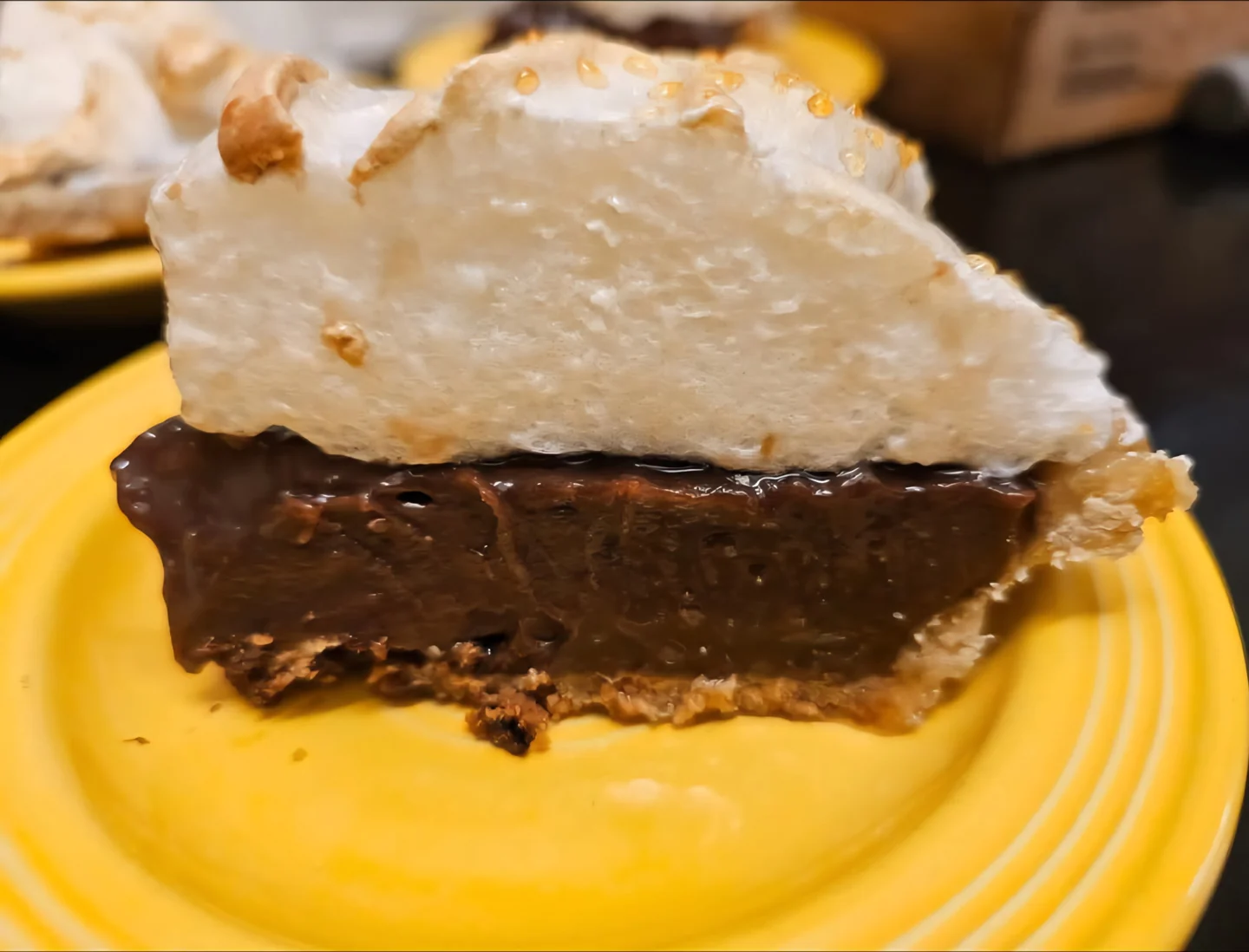 Pie with a chocolate-colored filling and meringue topping