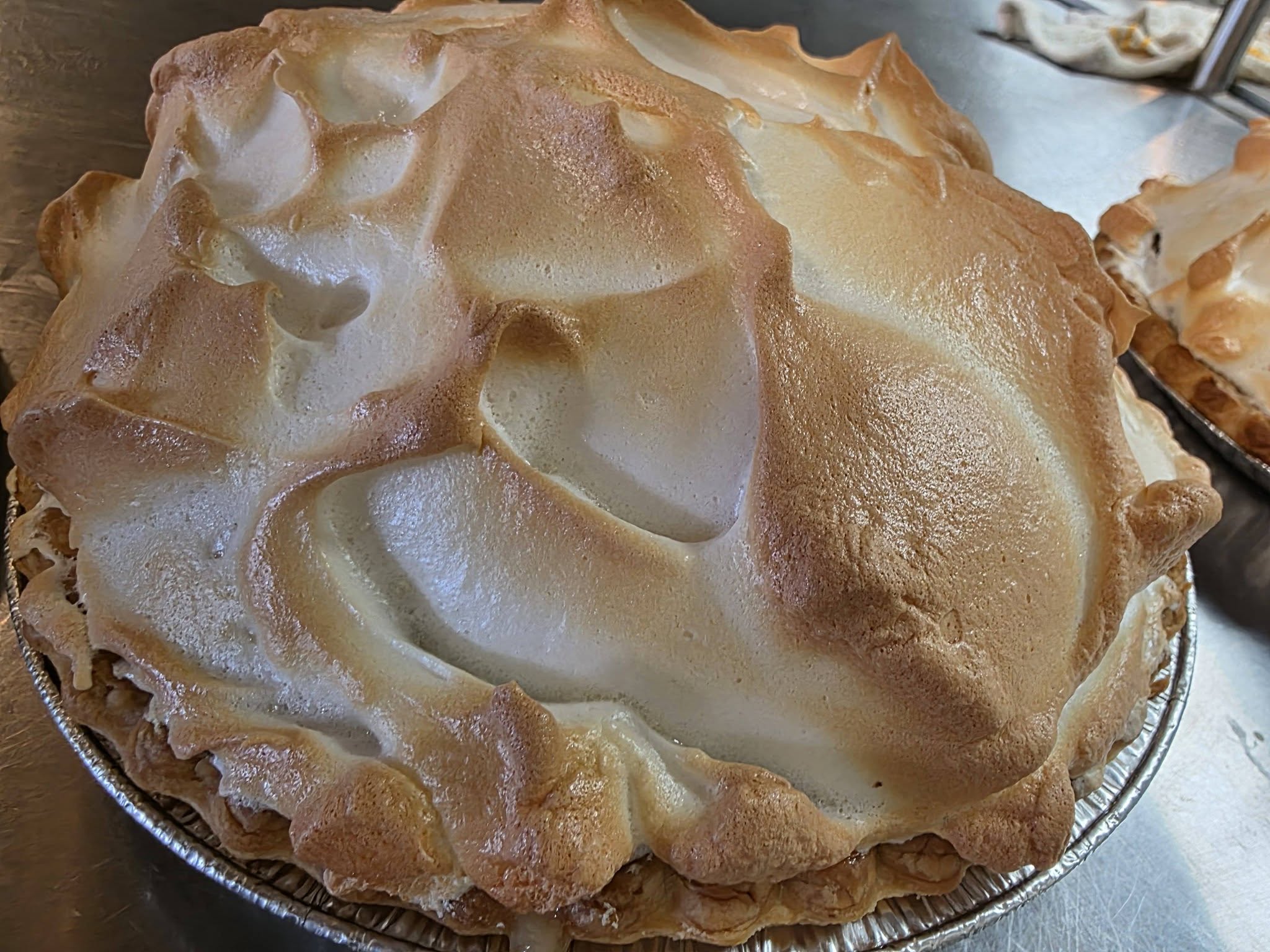 A whole pie with tall, toasted meringue peaks at Tim’s Diner